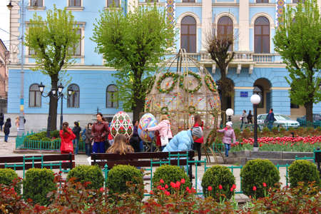 CHERNIVTSI, UKRAINE - APRIL 22, 2017: Unidentified people make photos nea big Easter eggs on central...