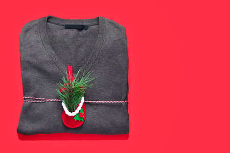 Sweater as a gift for the New Year. Festive mood. Christmas. Christmas tree branch in festive shoeの写真素材