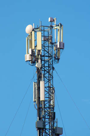 Relay tower with many antennas against the sky