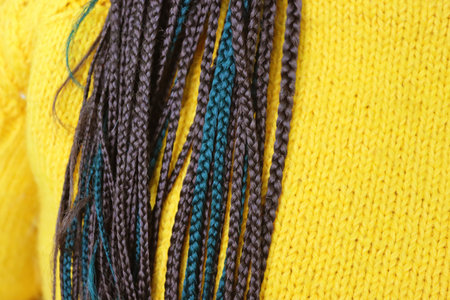 Girl with dreadlocks in a yellow sweater. Close up viewの写真素材