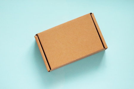 Craft Cardboard Box Container on the blue backgroundの写真素材