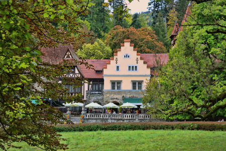Sinaia, Romania - October 14, 2023: Entrance to the Peles castle, with traditional Romanian houses, and restaurantのeditorial素材