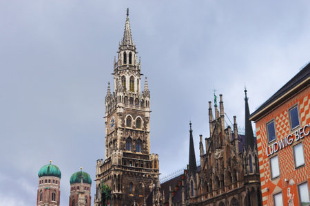 Munich, Germany - December 20, 2023: New city hall and towers of Frauenkirche Cathedral (left)のeditorial素材