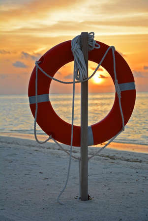 Life buoy against the backdrop of a beautiful sunsetの写真素材