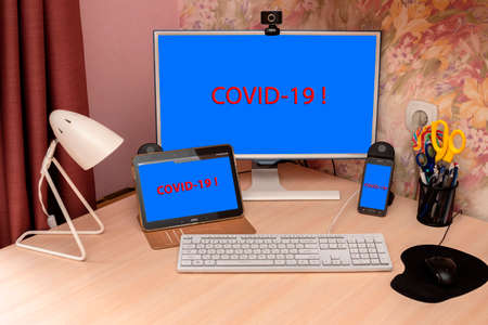 mobile phone tablet and computer monitor warn of COVID-19 pandemic in the world