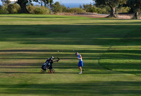 Golfers on the course during a sunny day. Taken in Catalonia, Spain.の写真素材