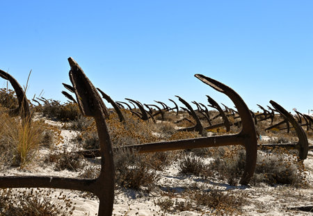Abandoned rusty anchor in the desert on a sunny day.の写真素材