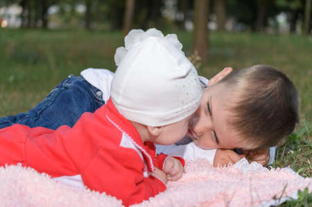 Underage boy with his little sister about something sweet deal.の写真素材