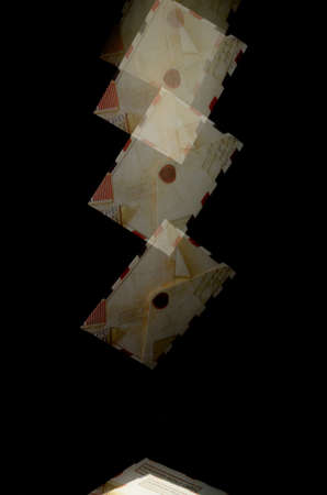 Preparation in the form of postal envelopes flying on a black background.の写真素材