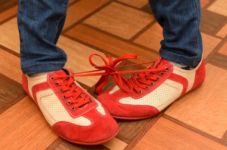 Bound shoelaces from two sports shoes.