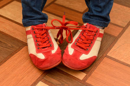 Bound shoelaces from two sports shoes.