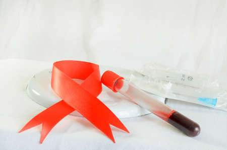 Blood sampling and analysis in a biochemical laboratory on a light background.