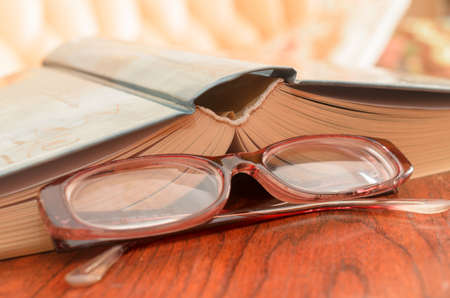 Lying open book and glasses.の写真素材