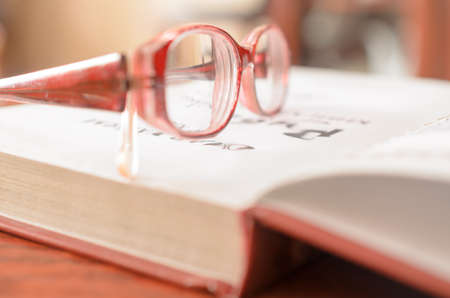 Lying open book and glasses.