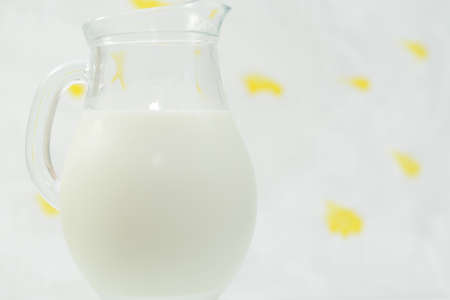 Fresh cow milk in a jar on a light background.の写真素材