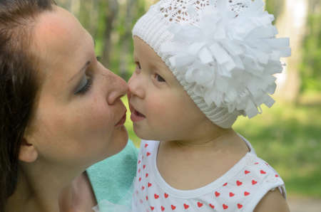 Happy mother and little daughter in the park.の写真素材