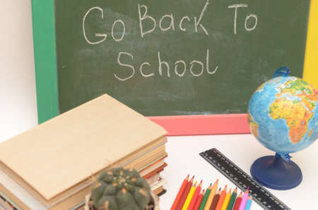 School supplies on a background of a school board with an inscription and on a light background