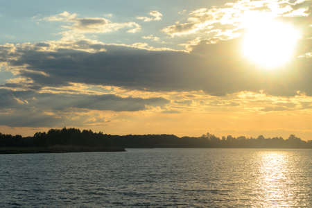 Sunset on a summer evening over the lakeの写真素材