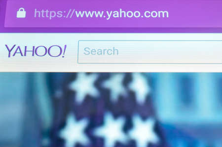 Brest, Belarus - June 28, 2017: Brand name yahoo mail on screen android phone. Search engine yahoo. The American flag is depicted in the background.のeditorial素材
