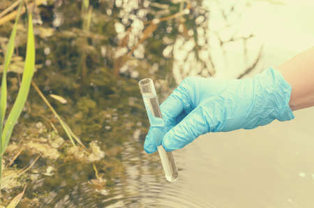 Taking a water test for analysis from a reservoir.