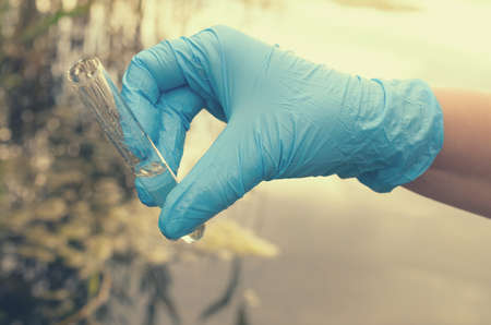 Taking a water test for analysis from a reservoir.の写真素材