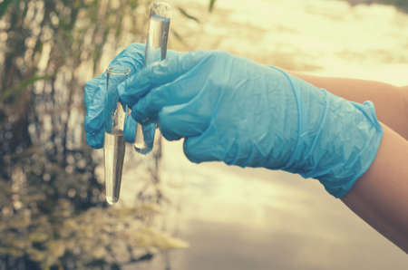 Taking a water test for analysis from a reservoir.の写真素材