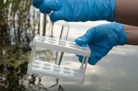 Taking a water test for analysis from a reservoir.