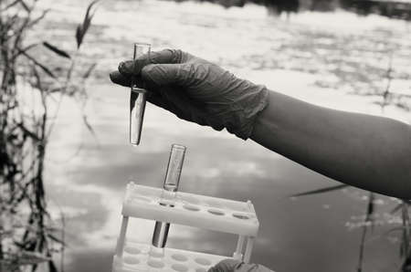 Taking a water test for analysis from a reservoir.の写真素材