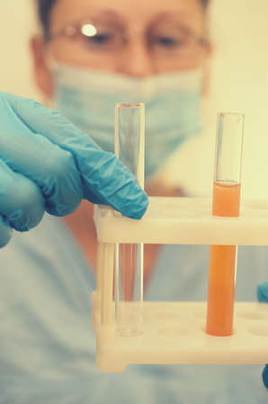 The doctor makes tests with a biological fluid.