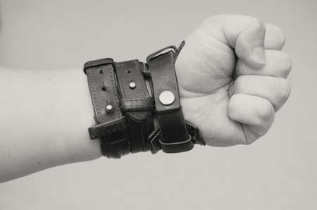 Modern fashionable leather and metal bracelets on the wrist.