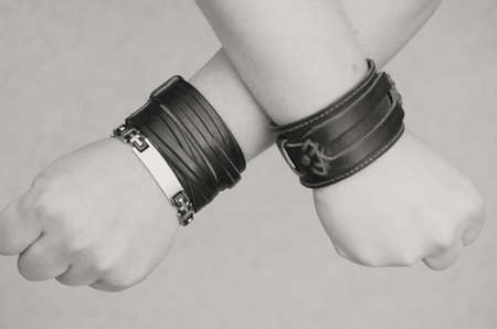 Modern fashionable leather and metal bracelets on the wristの写真素材