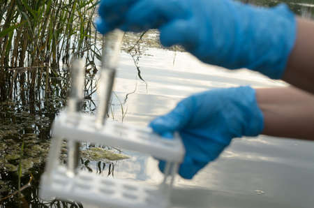Taking a water test for analysis from a reservoirの写真素材