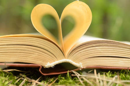 The pages of the opened book are stacked in the form of a heartの写真素材