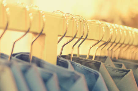 Many hangers in a row for clothes in the storeの写真素材