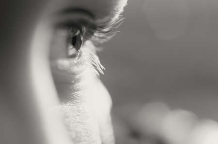 Blue eyes of a close-up boy look straight and in the sideの写真素材