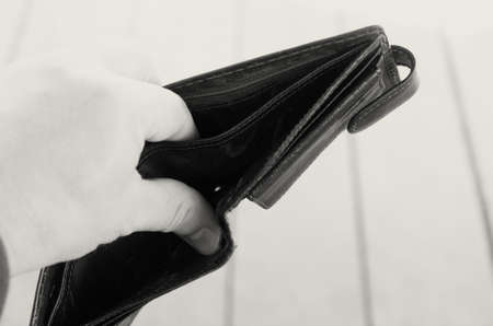 Empty open brown purse in one handの写真素材