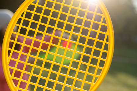 A tennis racket in his hand catches the ball in motionの写真素材