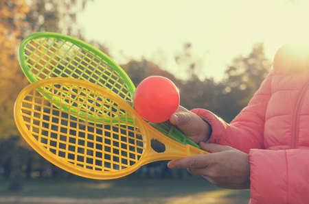 A tennis racket in his hand catches the ball in motionの写真素材