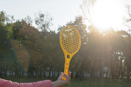 A tennis racket in his hand catches the ball in motionの写真素材