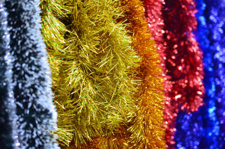 New Year's fluffy tinsel of foil red blue yellow flowers.の写真素材