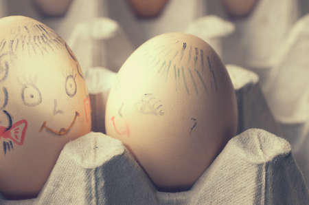 Eggs with painted merry muzzles in the tray