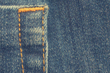 Textile texture of blue jeans with orange stitchingの写真素材