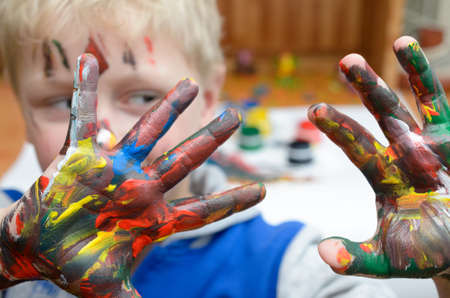 The children's palms, soiled with paint, amuse the child.の写真素材