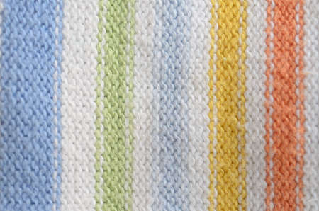 Textile texture of wool blue yellow green white red.