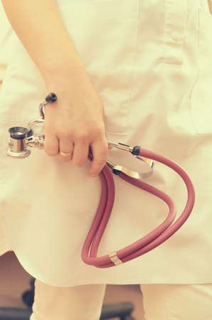 Doctor woman with a stethoscope in special medical clothesの写真素材