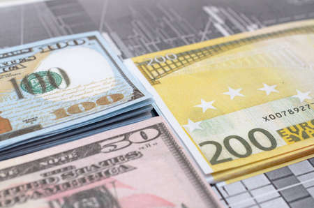 Money against the background of financial stock charts