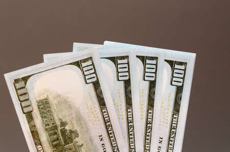 One hundred and fifty dollar bills, spread out in a fan