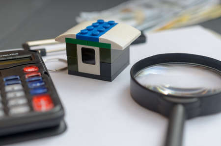 The concept of housing lending. Money, calculator, toy house