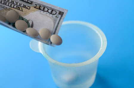 Tablets and banknotes. The concept of imposing medical drugsの写真素材