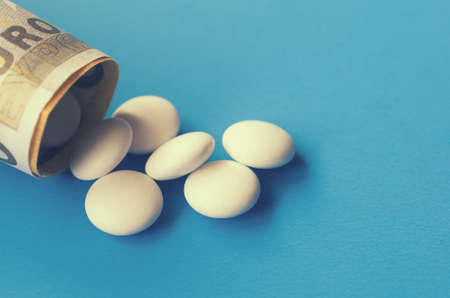 Tablets and banknotes. The concept of imposing medical drugsの写真素材
